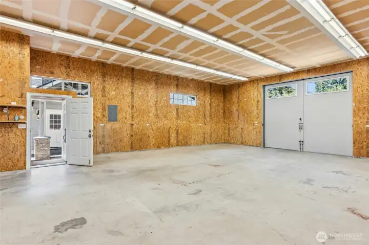 Inside the heated shop - not pictured is a private toilet, shop sink & full washer & dryer. Doorway showing access to the patio off the house.
