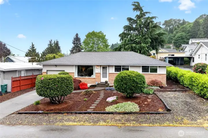Charming curb appeal welcomes you home with manicured landscaping, mature shrubs, and a classic rambler design that creates a warm first impression from the moment you arrive.