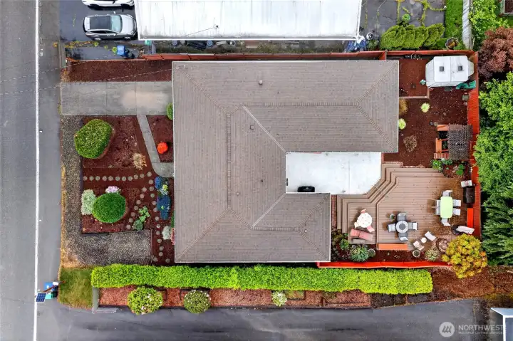 Bird’s-eye view highlights the home’s impressive lot layout, oversized entertainment deck, private fencing, and thoughtfully landscaped grounds that provide both privacy and functionality.