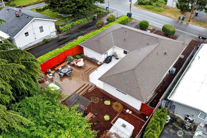 Aerial view highlights the large entertainment deck, private fenced yard, and spacious single-level layout with exceptional outdoor gathering areas.