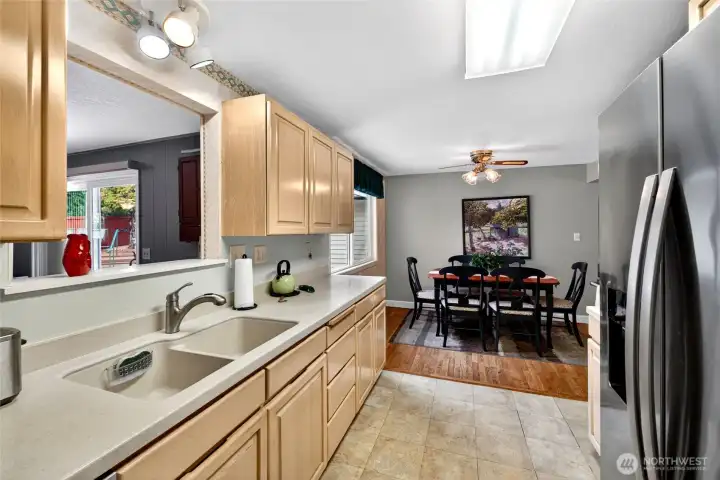 Bright and functional kitchen with generous counter space, abundant cabinetry, and an open connection to the dining area, making everyday living and entertaining feel effortless.