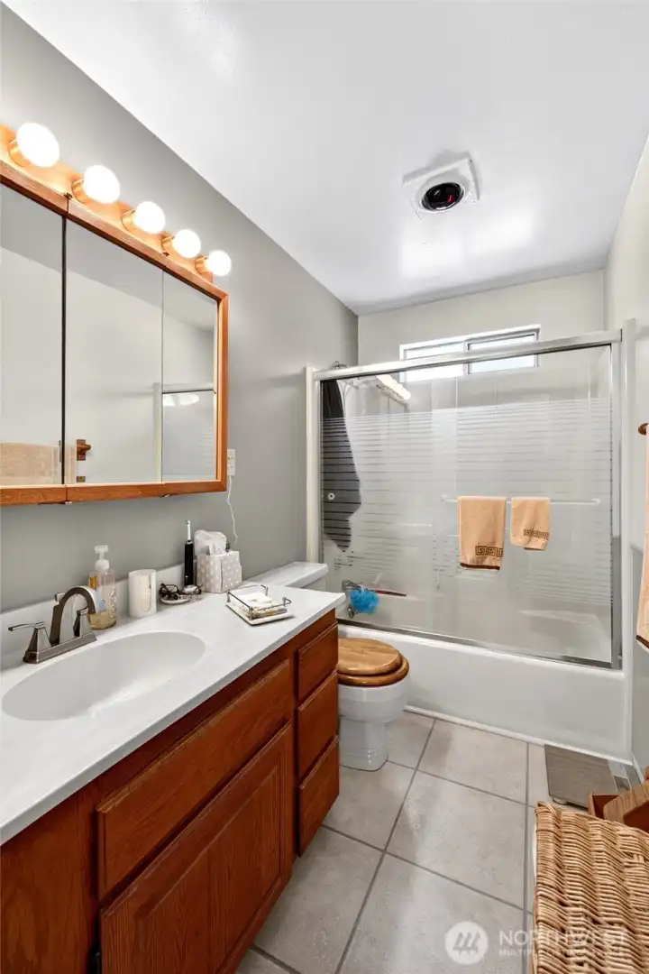 Spacious full bathroom with extended vanity counter space and a tub/shower combination designed for comfort and functionality.