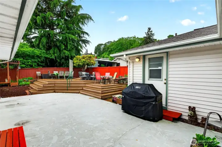 Spacious patio and multi-level entertainment deck create the perfect setting for outdoor dining, gatherings, and summer evenings.