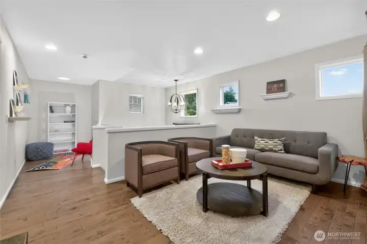 Upstairs Media Loft + Bonus WFH or Yoga space. Also, in the background, a hatch to additional attic storage space.