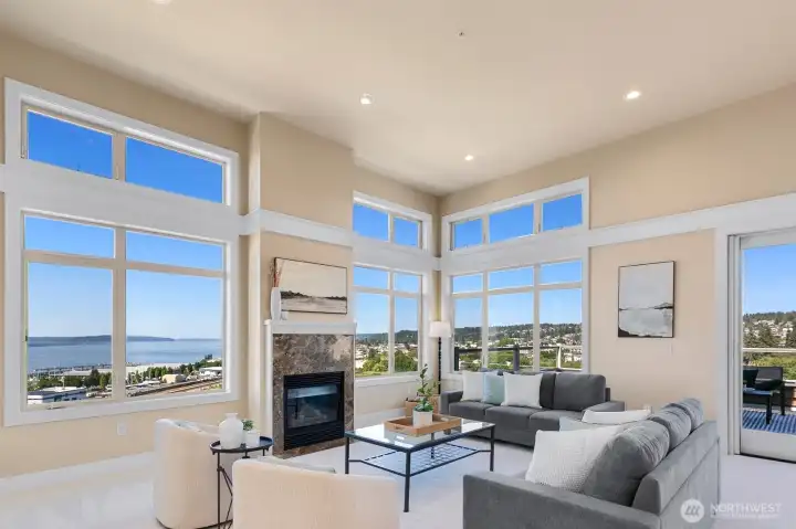 Light-filled living area with nearly 13-foot vaulted ceilings, expansive windows, and panoramic views.