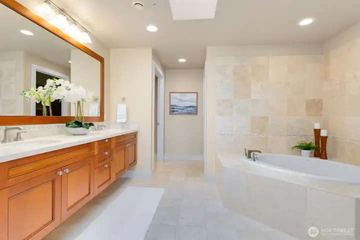 Spacious primary bathroom with double vanity, soaking tub, and walk-in shower.