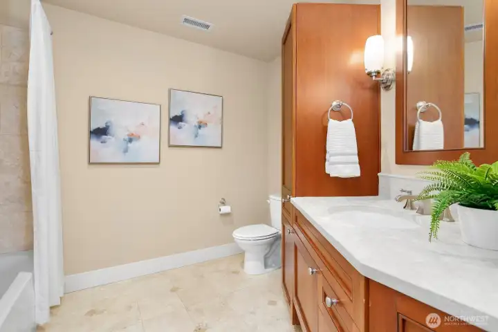 Full main bathroom with tile finishes and generous vanity space.