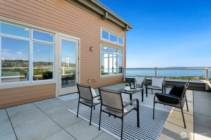 Oversized corner deck with generous outdoor living space and seamless access from the main living area.