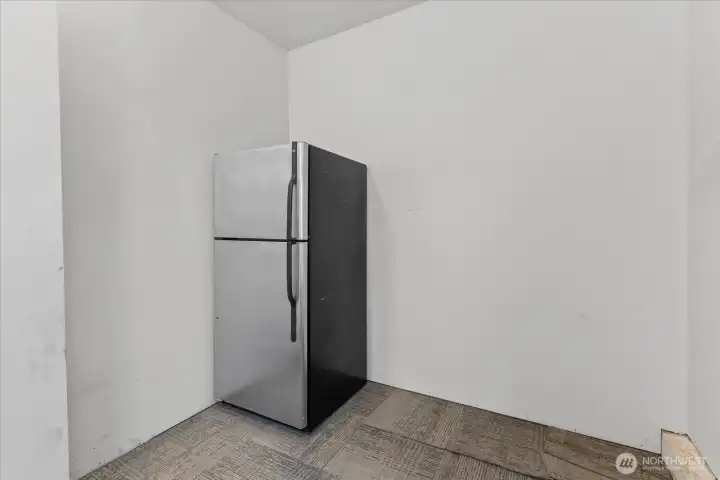 Unit 2: Main floor Laundry room with extra fridge. Unit 2: Main floor Laundry room with extra fridge.