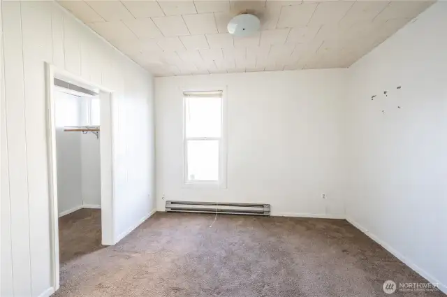 Main floor bedroom with walk-in closet and built-ins