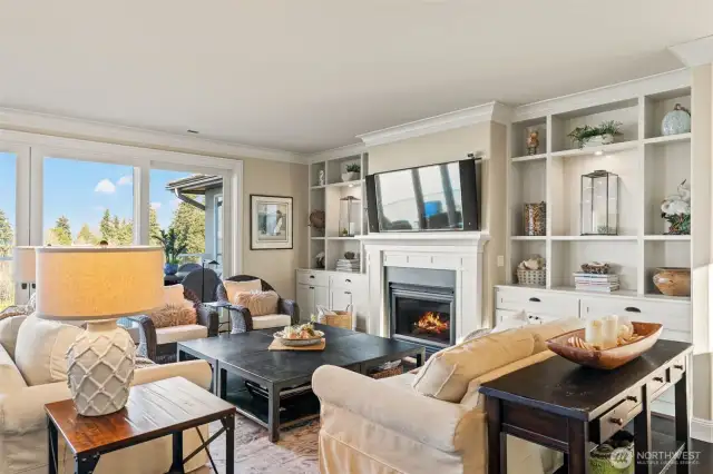 Impressive great room with gas fireplace and custom built in cabinetry.