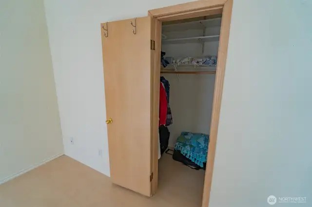 Walk in closet in primary bedroom.