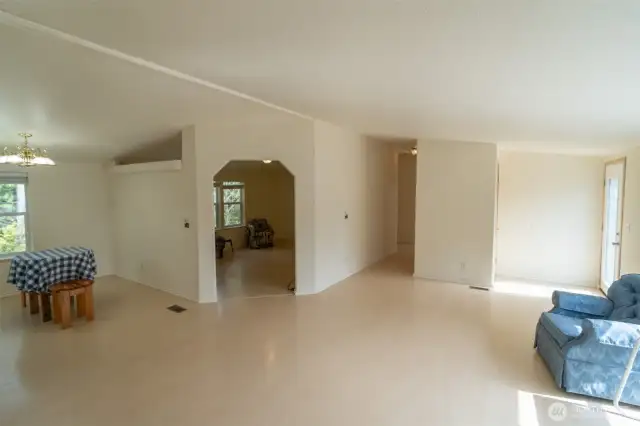 Front door on the far right that opens into a large room. Bonus room straight ahead with the hallway to 2 bedrooms.