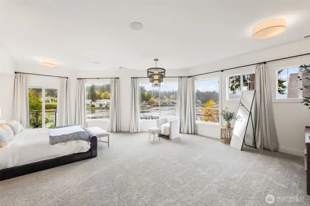 The main floor primary suite is a retreat with views down the bay towards the Olympic Mountains