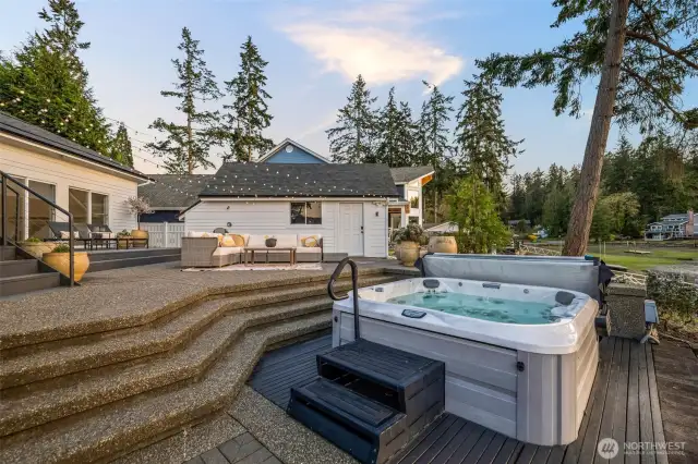 Next to the fabulous boathouse sits the outdoor hot tub,  in the perfect spot to take in the Bay sunsets, and the view of those around gathering around the fire pit