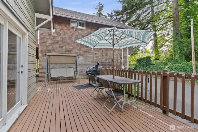 From the kitchen back door.  Deck with plenty of room for entertaining.  Circular driveway continues to the right.