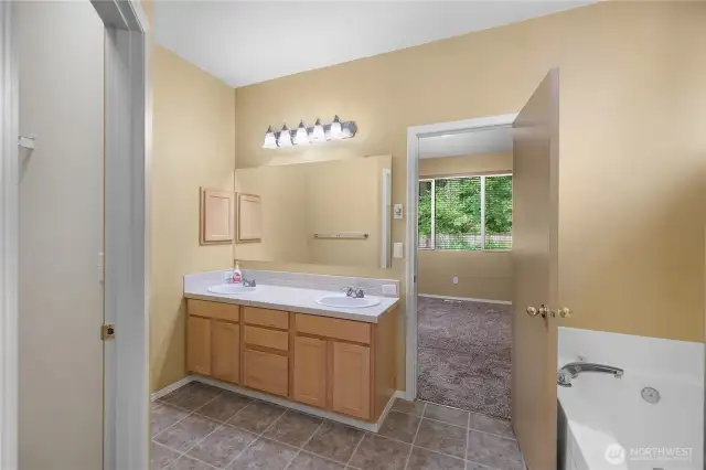 Primary bathroom offers double sinks, soaking tub and stall shower.