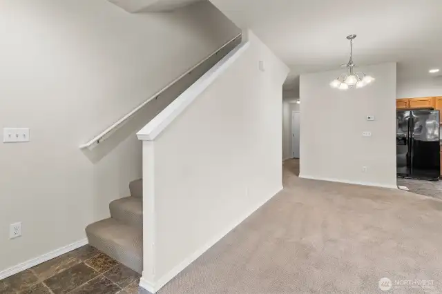 Staircase leads up to three bedrooms and two full bathrooms.