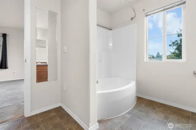 Soak your cares away in the tub (shower head hot shown).