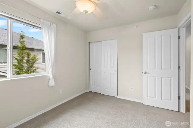 Another view of the first guest bedroom showing the ceiling fan.