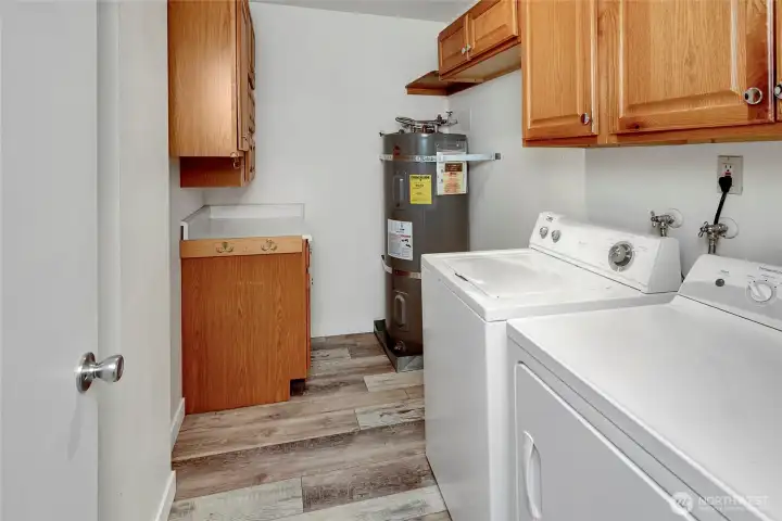 In-unit laundry room with built-in cabinetry