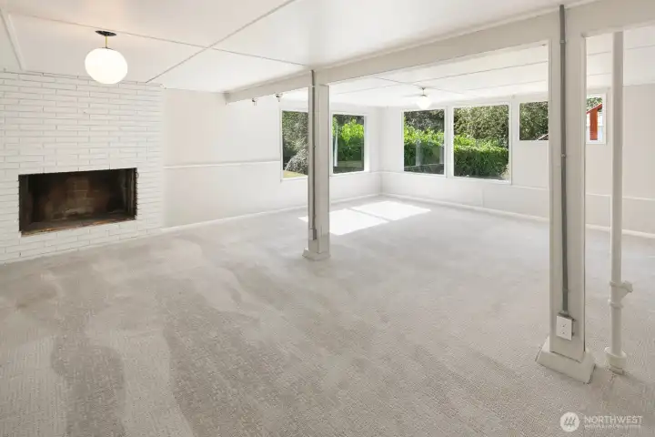 Large downstairs rec room with cozy fireplance and views of the backyard.