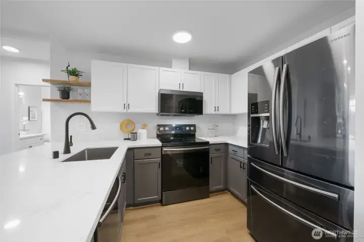 The beautiful quartz coutnertops and plenty of work space.