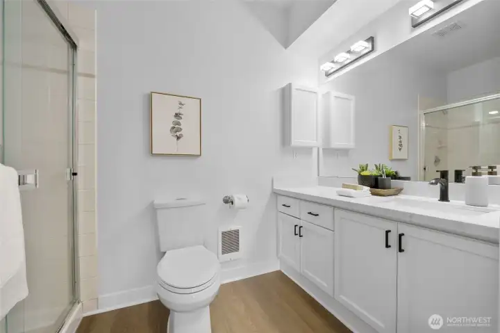 New floors, quartz counters and fixtures in the 3.4 bath.