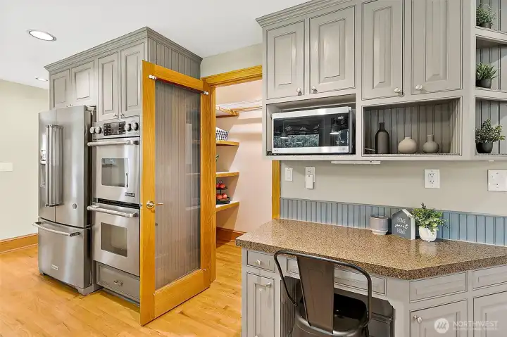Kitchen with pantry and additional counter space.