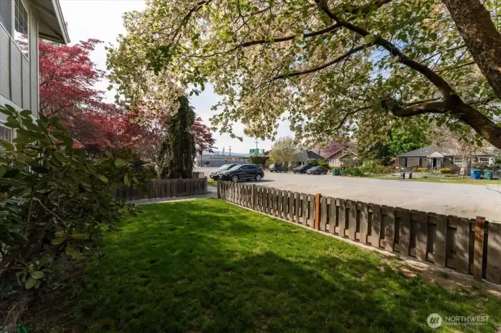 Fenced, landscaped grassy yard.