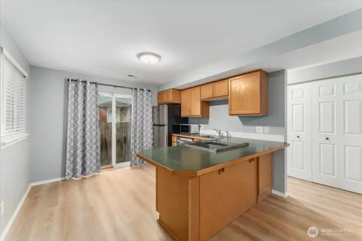Kitchen with sit up bar and sliding glass doors leading to the private patio.