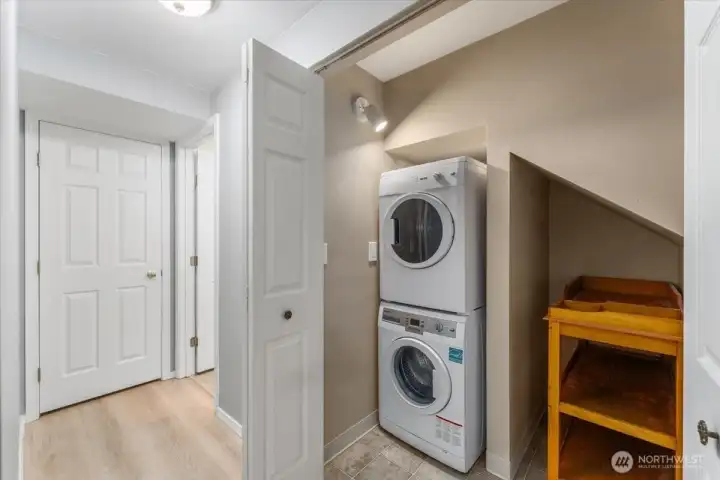 Main level hallway with washer and dryer looking towards the bathroom.