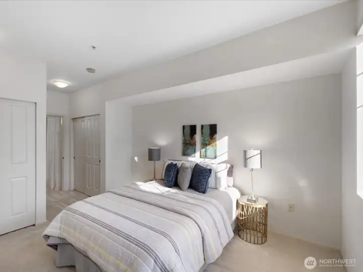 Bedroom with natural light, neutral finishes, and proximity to ensuite bathroom. Functional layout supports privacy and separation between living spaces.