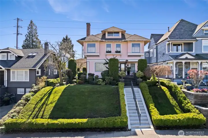 Classic hedges frame the borders and walkway.