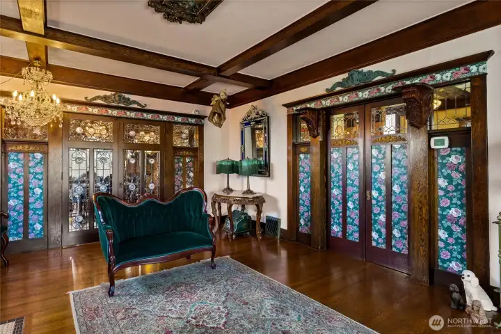 doors to the right are to the entry, glass paneled doors open to the dining room.