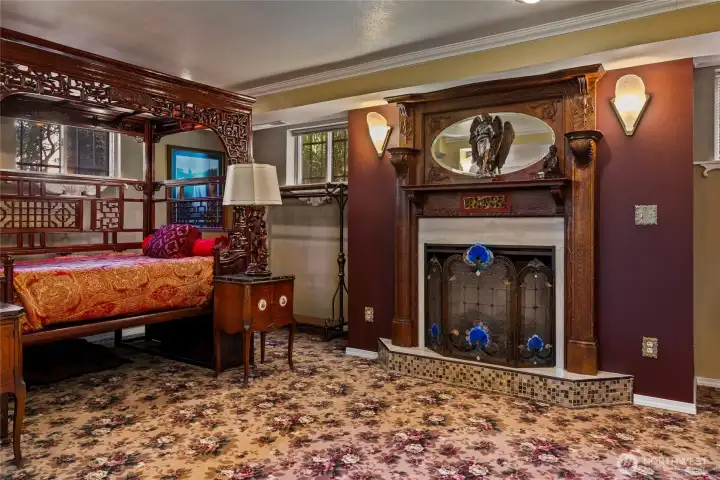 Fireplace in the lower level with antique mantle.