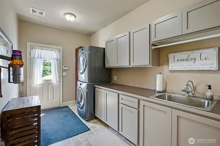 Laundry room with new stainless steel sink, exit to patio and deck