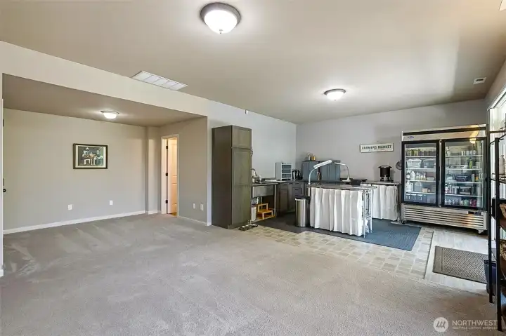 Basement, cabinets installed 2023, midline grade with soft close drawers, utility sink and fridge included, gas hook up next to fridge, steel tables not included in sale.