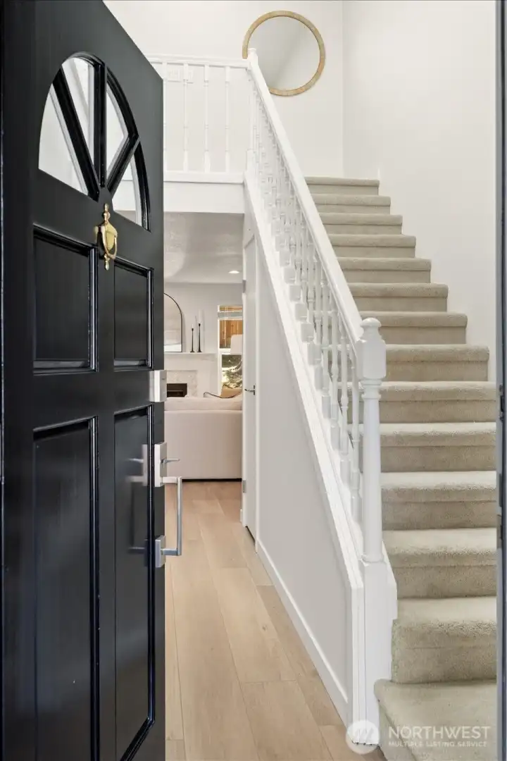 The residence features sophisticated modern touches throughout, including brand-new flooring, fresh paint, and fully remodeled kitchen and bathrooms.