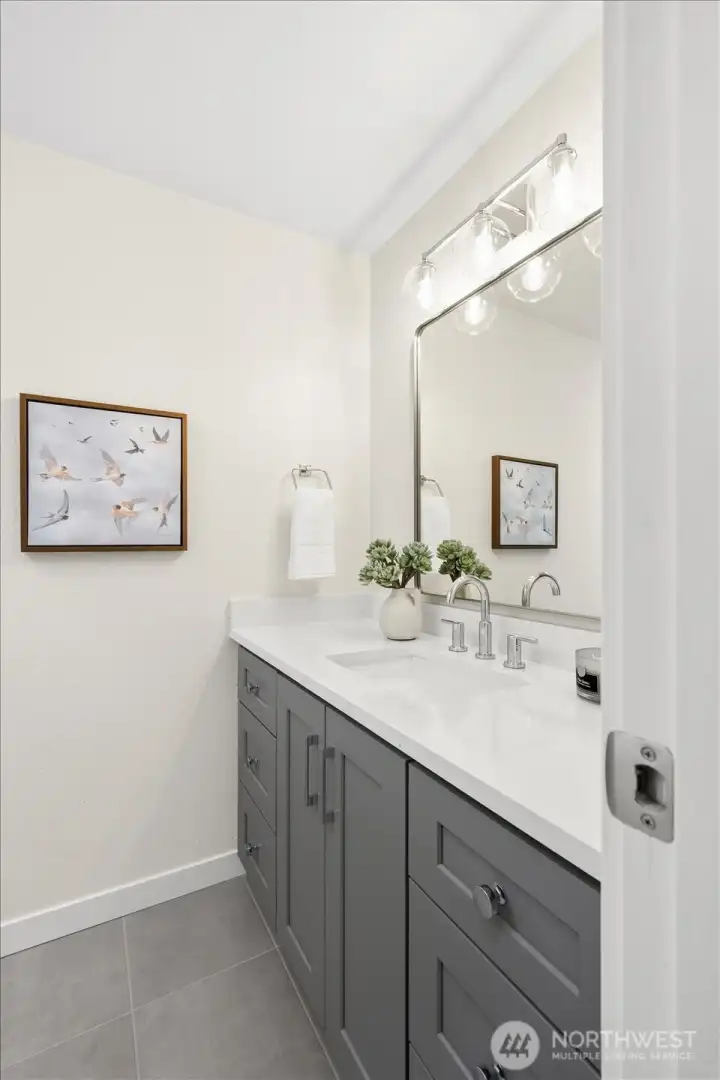 Designer-finished en-suite with a beautifully updated vanity, new sink, and polished modern fixtures.
