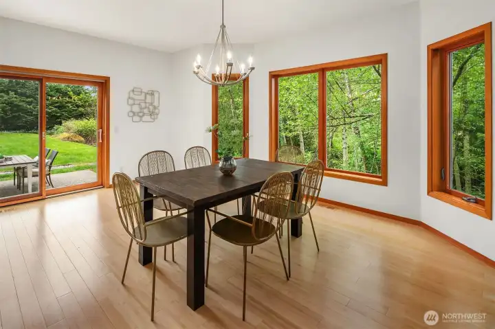 Light filled dining room overlooking lush, private backyard. Light filled dining room overlooking lush, private backyard.