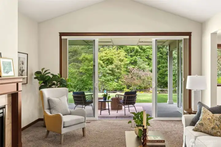 Double sliding doors with access to the beautiful covered patio is adorned with vaulted ceilings