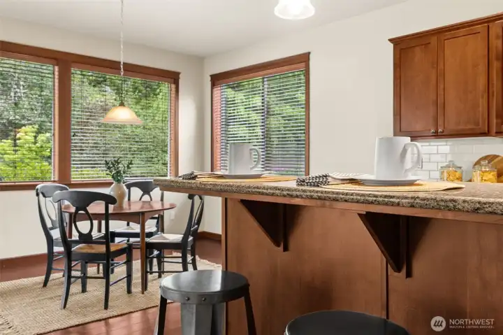 Convient raised bar for extra seating or kitchen prep work and open to the breakfast nook with access to the covered patio
