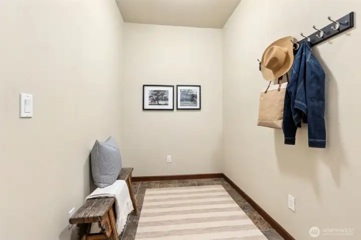 Mud room off garage offers opportunity for additional storage and flex usage