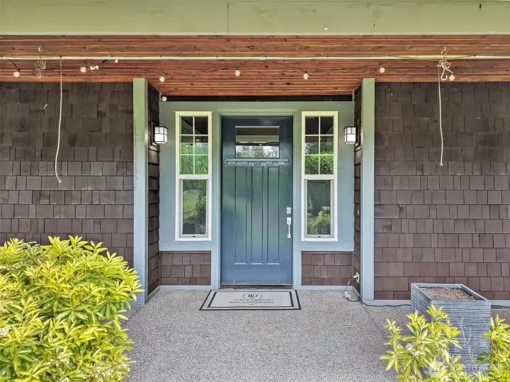 Covered front porch with wood ceiling detail, stone-accent columns, and a quiet seating area that sets a warm first impression. Covered front porch with wood ceiling detail, stone-accent columns, and a quiet seating area that sets a warm first impression.