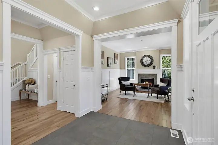 Inviting entry with warm wood flooring, fresh finishes, and an open view into the formal living room. Inviting entry with warm wood flooring, fresh finishes, and an open view into the formal living room.