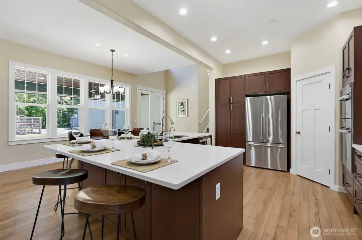 Remodeled kitchen with new quartz countertops, new solid wood soft-close cabinets, RO water, and high-end appliances opening to the main living area Remodeled kitchen with new quartz countertops, new solid wood soft-close cabinets, RO water, and high-end appliances opening to the main living area