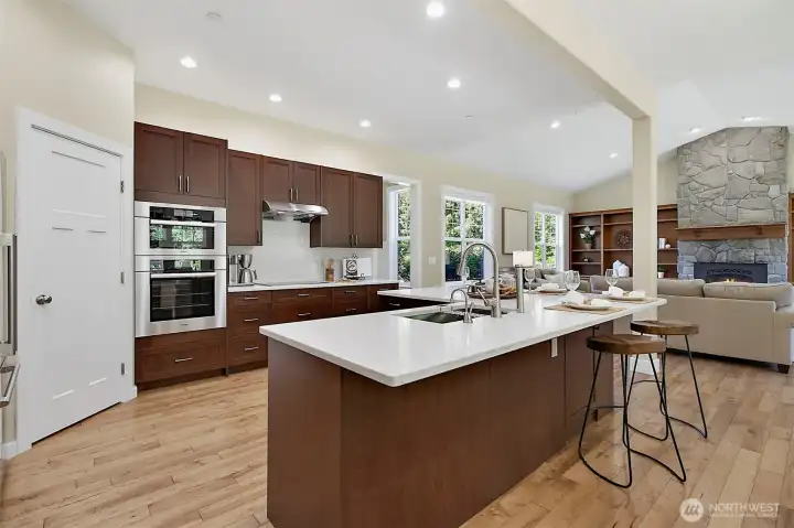 Remodeled kitchen with new quartz countertops, new solid wood soft-close cabinets, RO water, and high-end appliances opening to the main living area Remodeled kitchen with new quartz countertops, new solid wood soft-close cabinets, RO water, and high-end appliances opening to the main living area