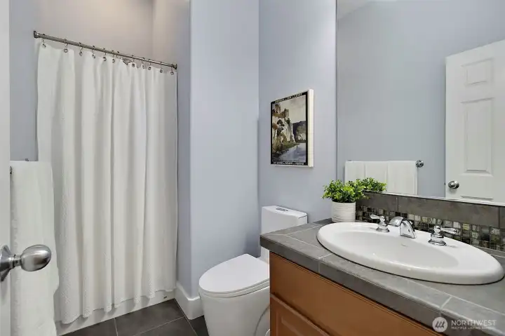 Full bathroom with shower/tub combo, dual sinks, and a clean, refreshed feel. Full bathroom with shower/tub combo, dual sinks, and a clean, refreshed feel.