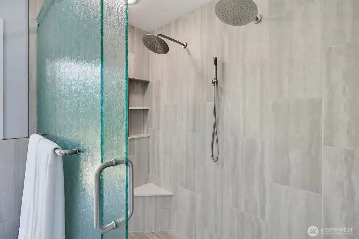 Updated primary shower with new tile, glass door, and dual rain shower heads. Updated primary shower with new tile, glass door, and dual rain shower heads.